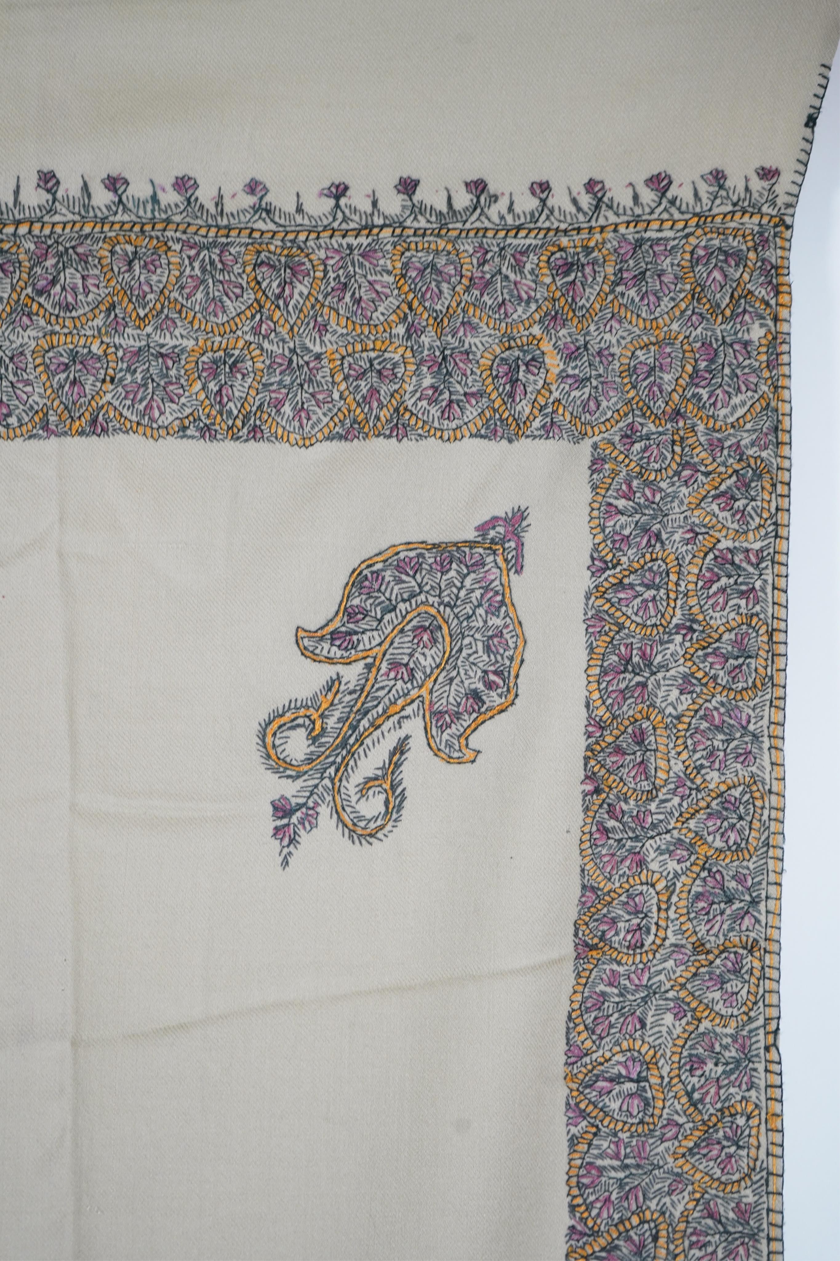 A 20th century ladies mushroom coloured Kashmiri black, yellow and grey silk embroidered stole, with two fine fringe edges, 190 cm long. Condition - a small moth hole near the embroidered border and one mark near one end